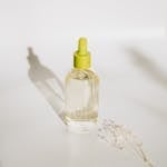 Elegant minimalist shot of an essential oil bottle with a dropper against a soft background.
